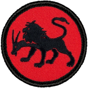 May include: A red embroidered patch with a black lion-like creature with a horn on its head. The creature is facing left and has a mane.