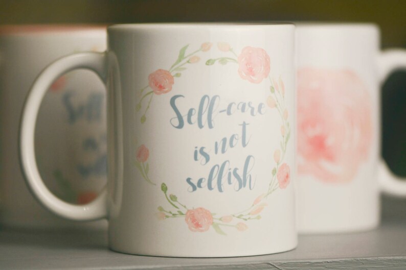 May include: White ceramic mug with a floral design and the text "Self-care is not selfish".