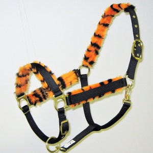 May include: Black nylon horse halter with orange and black tiger print fur trim.