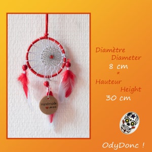 May include: Red and white dreamcatcher with red feathers and a small brown tag that says "Handmade with love". The dreamcatcher is 8 cm in diameter and 30 cm tall.