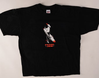 May include: Black t-shirt with a white and red airplane graphic and the text "PEARL JAM" in red.