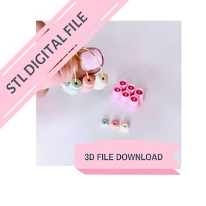 May include: A 3D printed STL file download for a set of colourful beads. The beads are in shades of pink, green, and white. The image also shows a pink plastic mould with six holes.