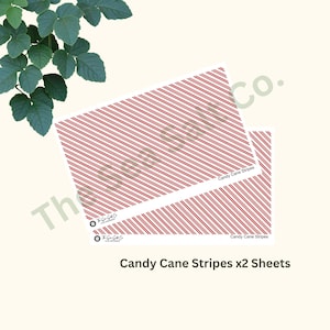 May include: Two sheets of white paper with a red and white candy cane stripe pattern. The text "Candy Cane Stripes x2 Sheets" is printed at the bottom of the image.