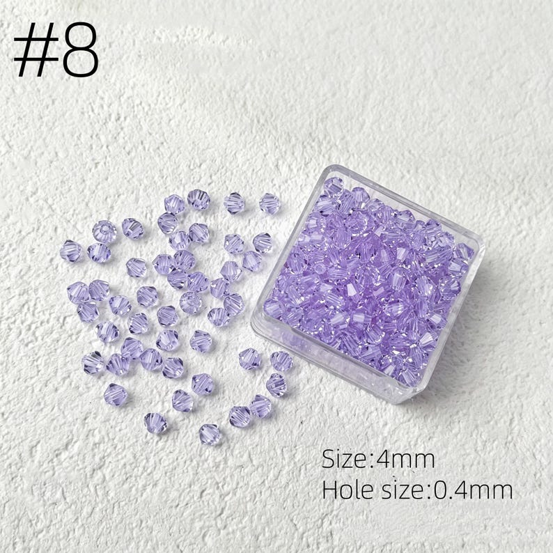 May include: A clear plastic container filled with small, faceted, lavender beads. Some beads are scattered around the container. The text "#8" is in the upper left corner. The text "Size: 4mm" and "Hole size: 0.4mm" are in the lower right corner.