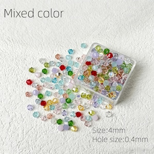 May include: A collection of mixed-color beads, scattered around a clear plastic container. The beads are in various colors, including red, green, blue, yellow, and purple. The text "Mixed color" is at the top. The size is 4mm, and the hole size is 0.4mm.