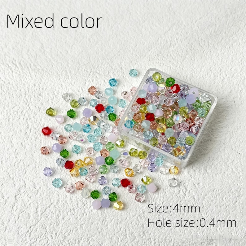 May include: A collection of mixed-color beads, scattered around a clear plastic container. The beads are in various colors, including red, green, blue, yellow, and purple. The text "Mixed color" is at the top. The size is 4mm, and the hole size is 0.4mm.