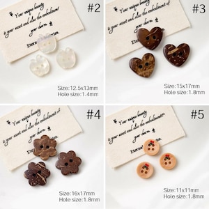 May include: A collection of decorative buttons in various shapes and materials. Includes apple-shaped, heart-shaped, and flower-shaped buttons, as well as round buttons with floral accents. Sizes range from 11mm to 17mm.