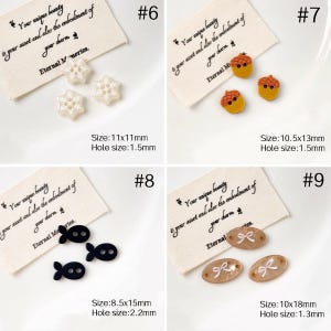 May include: A collection of decorative buttons in various shapes and colors. Includes snowflake, acorn, fish, and bow designs. Each button has a hole for sewing. Sizes range from 8.5mm x 15mm to 11mm x 11mm.