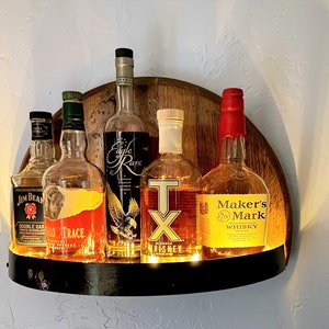 Illuminated whiskey barrel liquor display shelf perfect for displaying your bar collection, handcrafted from Kentucky bourbon barrel