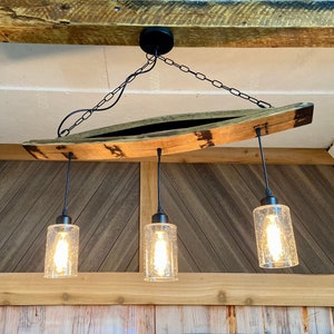 Unique ceiling pendant light from authentic bourbon barrels staves, ideal for bar or man cave, adds warmth and character