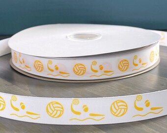 May include: White ribbon with a repeating pattern of yellow water polo players and balls. The ribbon is rolled up on a spool.