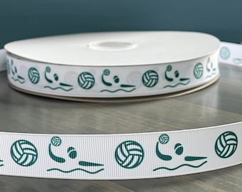 May include: White ribbon with a repeating pattern of green water polo players and balls. The ribbon is rolled up on a spool.