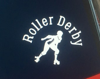 May include: White vinyl sticker featuring a silhouette of a roller derby skater with the text "Roller Derby" in a semi-circular shape around the skater.
