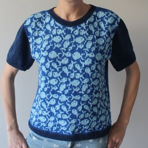 May include: A blue and light blue knit short-sleeved sweater with a fish pattern.