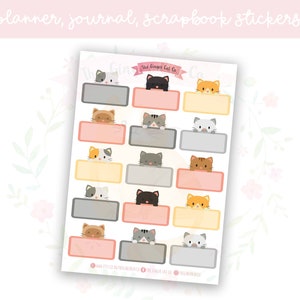 May include: A sheet of 15 planner, journal, or scrapbook stickers featuring cute cats peeking out from behind colorful boxes. The text "The Crafty Cat Co." is at the top of the sheet.