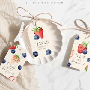 May include: Three watercolor thank you tags with a strawberry and blueberry design. The tags say "Thank you berry much", "Thanks Custom text with love", and "Thank you berry much".