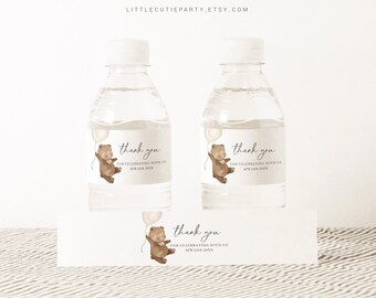 May include: Water bottle labels with a brown bear holding a balloon. The labels say "thank you for celebrating with us" and include a date.