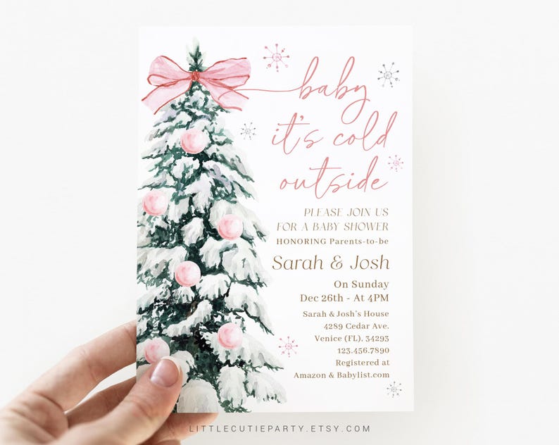May include: A baby shower invitation card featuring a watercolor illustration of a snow-covered Christmas tree adorned with pink ornaments and a bow. The text reads "baby it's cold outside" and invites guests to celebrate Sarah & Josh.