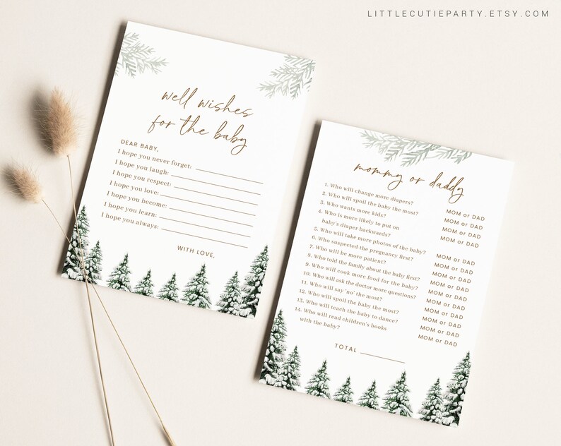 May include: Two baby shower game cards with a winter forest theme. One card reads "Well Wishes for the Baby" and the other reads "Mommy or Daddy". Both cards have a white background with green and gold accents.