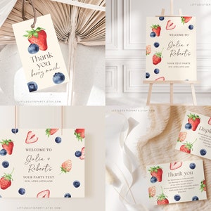 May include: Printable digital download for a bridal shower. The design features watercolor illustrations of strawberries and blueberries on a cream background. The text reads "Welcome to Julia + Robert's Your Party Text Sun, April 26th 20XX".