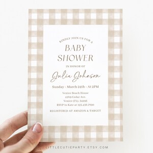 May include: A beige and white gingham baby shower invitation with the text "Kindly join us for a baby shower in honor of Julia Johnson. Sunday, March 24th - At 2PM. Venice Beach House, 4289 Cedar Ave., Venice (FL), 34295. RSVP to Kate at 123.456.7890. Registered at Amazon & Target."