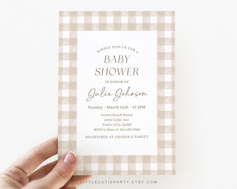 May include: A beige and white gingham baby shower invitation with the text "Kindly join us for a baby shower in honor of Julia Johnson. Sunday, March 24th - At 2PM. Venice Beach House, 4289 Cedar Ave., Venice (FL), 34295. RSVP to Kate at 123.456.7890. Registered at Amazon & Target."