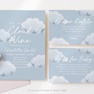 May include: Blue and white baby shower invitation with a cloud theme. The invitation says "We are on Cloud Nine" and includes the name Charlotte Smith. The invitation also includes the date, time, and location of the shower. There are also two cards for a diaper raffle and a book request for the baby.