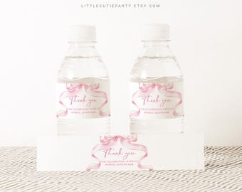May include: Two clear plastic water bottles with pink ribbon and watercolor bow labels. The labels say "Thank you for celebrating with us Sunday, August 21st". There is also a separate label with the same design and text.