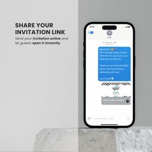 May include: A smartphone displays a baby shower invitation. The screen shows a text message with an invitation and a link. The text reads "Hey Sarah! We're having a baby shower!" and "Baby Shower Invitation". The phone is on a light gray surface.