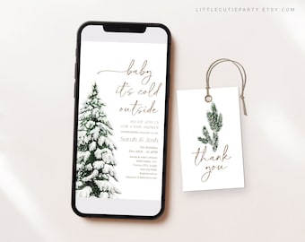 May include: A smartphone displays a baby shower invitation with the text "baby it's cold outside." A snow-covered evergreen tree is on the left. A matching tag with "thank you" is on the right.