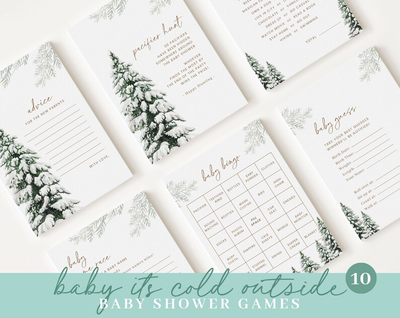 May include: A collection of baby shower games with a winter theme. The cards feature illustrations of snow-covered pine trees and include games like "Pacifier Hunt" and "Baby Bingo." The phrase "baby it's cold outside" is written at the bottom.