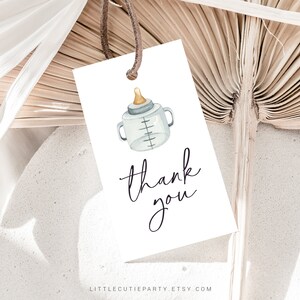 May include: White thank you tag with a watercolor illustration of a baby bottle and the text "thank you".