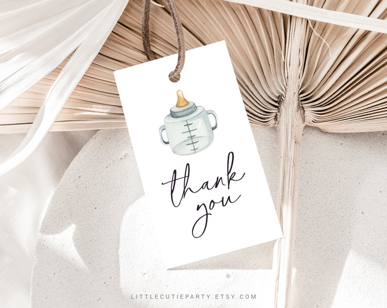 May include: White thank you tag with a watercolor illustration of a baby bottle and the text "thank you".