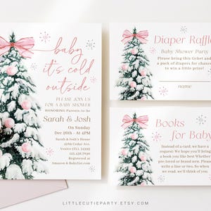 May include: A set of baby shower invitations and inserts with a winter theme. The main invitation features a watercolor Christmas tree with pink ornaments and a bow. Text includes "baby it's cold outside" and event details.