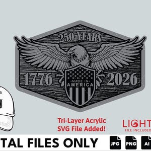 Puede incluir: Diseño gráfico con un águila con las alas extendidas, un escudo con estrellas y rayas, y el texto "250 YEARS 1776-2026 MADE IN AMERICA." También se muestra una gorra de béisbol con el mismo diseño. Archivos digitales disponibles.