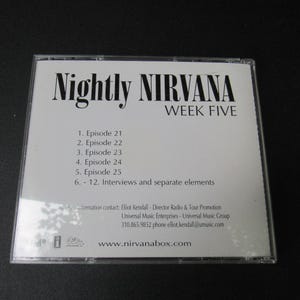May include: A clear plastic CD case with a white insert. The insert reads "Nightly NIRVANA WEEK FIVE" in black text. Below, episode titles are listed. The website www.nirvanabox.com is also visible.