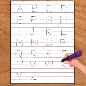 May include: A white practice worksheet featuring the uppercase English alphabet from A to Z in a dotted font. The letters are arranged in rows on lined paper with blue top and bottom lines and a dashed middle line. A purple crayon is shown.