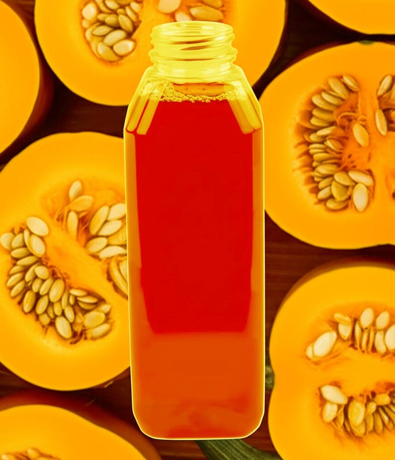 May include: A clear plastic bottle filled with orange-red liquid, likely juice or a beverage, is centered in the image. The bottle is surrounded by halved pumpkins, showcasing the orange flesh and seeds. The background is a wooden surface.