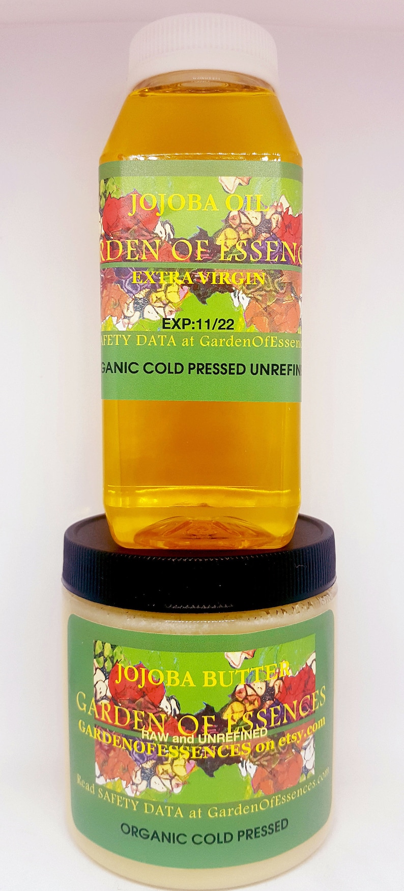 May include: Two bottles of organic cold-pressed jojoba oil and butter from Garden of Essences. The oil bottle is clear with a green label that says "Jojoba Oil Garden of Essences Extra Virgin EXP:11/22 Safety Data at GardenOfEssences.com Organic Cold Pressed Unrefined". The butter jar is white with a green label that says "Jojoba Butter Garden of Essences RAW and UNREFINED GARDENOFESSENCES on etsy.com Read Safety Data at GardenOfEssences.com Organic Cold Pressed".