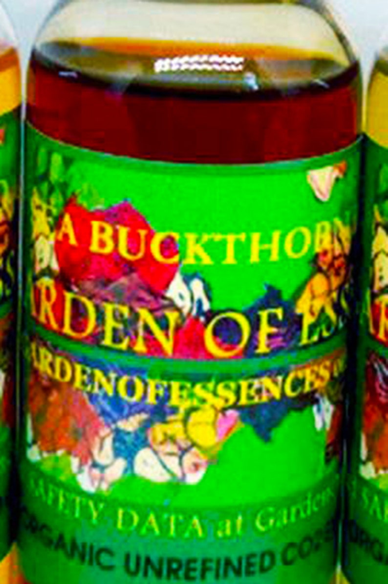 May include: A glass bottle with a green label that reads "A Buckthorn Garden of Essences" and "Organic Unrefined Cold Pressed Oil". The bottle contains a dark red liquid.