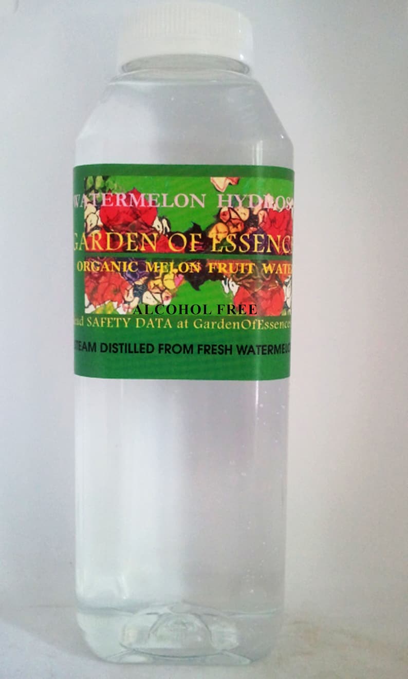 May include: A clear plastic bottle with a white cap, filled with a transparent liquid. The label features the text "Watermelon Hydrosol" and "Garden of Essence" with floral illustrations. The label also states "Alcohol Free".