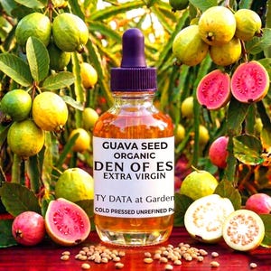 May include: A clear glass bottle with a purple dropper filled with amber liquid, labeled "GUAVA SEED ORGANIC DEN OF ES EXTRA VIRGIN." The image features guava fruits, some halved to reveal pink flesh, and seeds, set against a green foliage background.