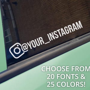 May include: A white vinyl decal featuring the Instagram camera icon and the text @YOUR_INSTAGRAM applied to a dark car window. The text CHOOSE FROM 20 FONTS & 25 COLORS! is displayed in white lettering against the light green car body panel.