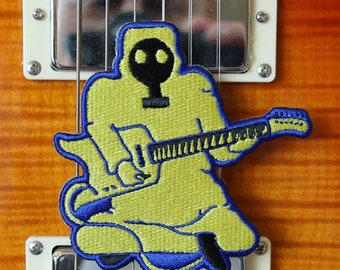 Toppa termoadesiva del chitarrista di fusione nucleare microtonale volante Banana Guy - King Gizzard & the Lizard Wizard