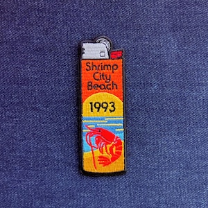 May include: A white ceramic mug with a black handle and the text "But First, Coffee" in a black, handwritten-style font. The mug is on a white surface.