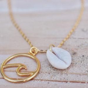 Gold wave necklace with cowrie shell