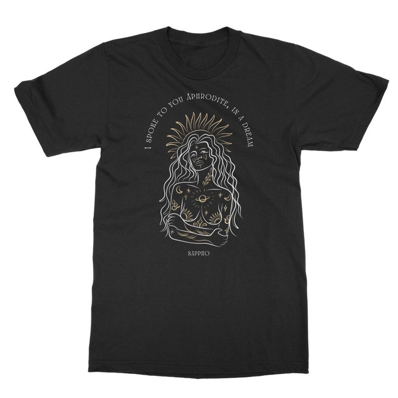 May include: Black t-shirt with a gold and white illustration of a woman with a crown of stars and the text "I spoke to you Aphrodite, in a dream" and "Sappho" at the bottom.