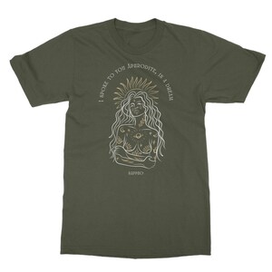 May include: A green t-shirt with a white outline of a woman with a sun halo and celestial tattoos. The text "I spoke to you Aphrodite, in a dream" is written in a gold script around the woman's head. The text "Sappho" is written in gold at the bottom of the shirt.