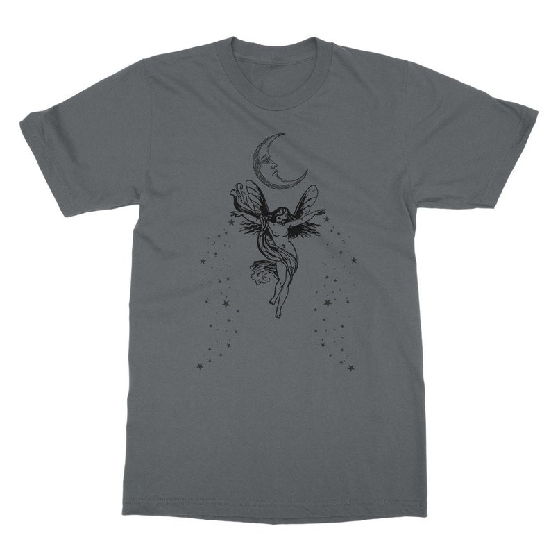 May include: A dark gray t-shirt with a black and white illustration of a fairy flying with wings outstretched. The fairy is surrounded by stars and a crescent moon.