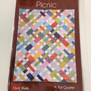 May include: A quilting pattern called "Picnic" by Cluck Cluck Sew. The pattern is for a quilt made with fat quarters and comes in 6 sizes.
